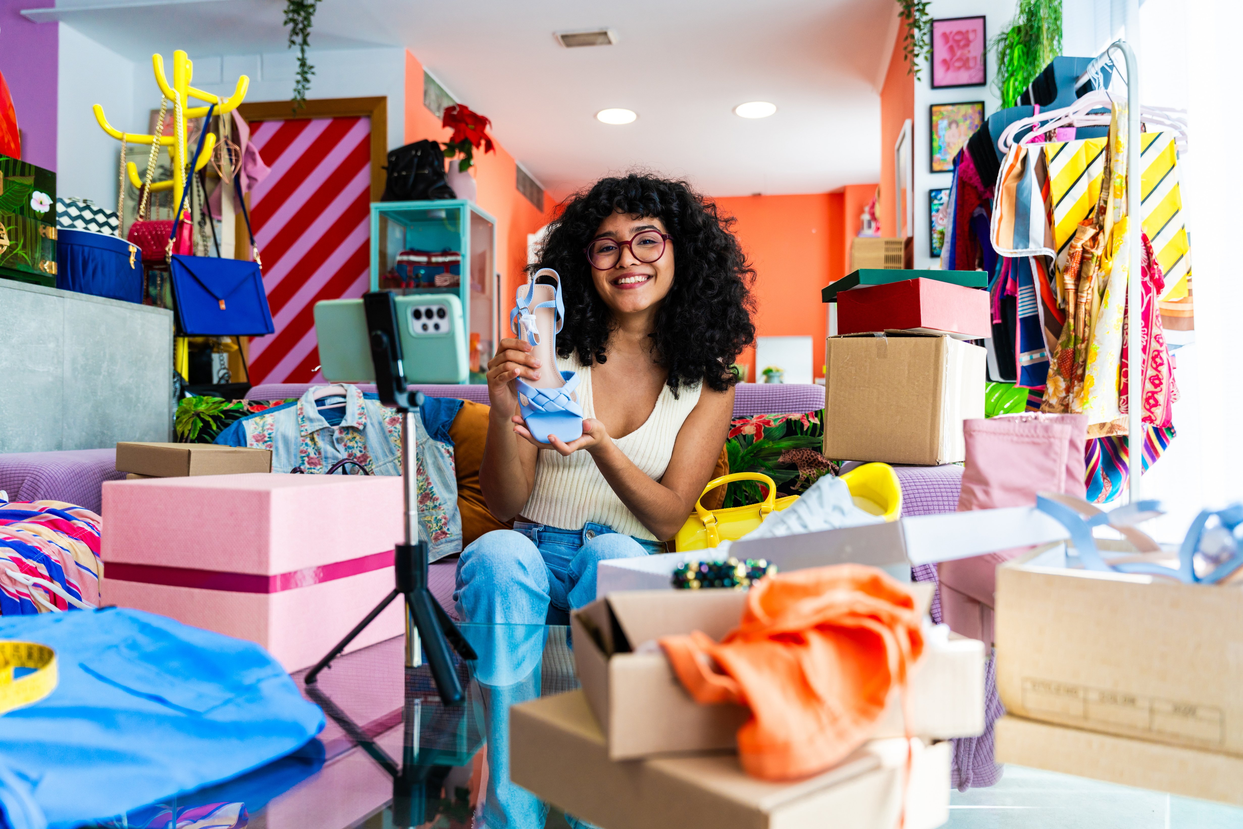 Beautiful young hispanic woman managing her home e-commerce busi